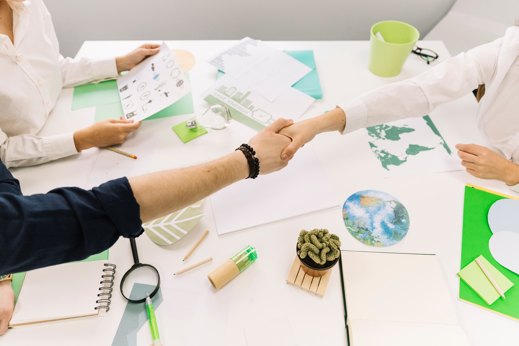 businessman shaking hands with his partner desk